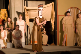 Andrea Braddy (masked) and ensemble members in Electra