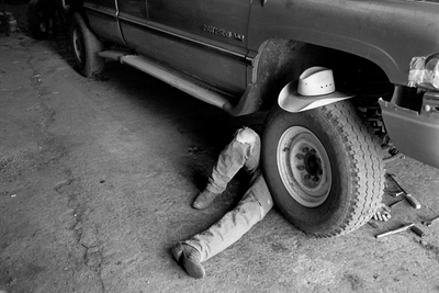 John Neumann works on his pickup, Cactus Flat, South Dakota. (2008) -- photo by Danny Wilcox Frazier