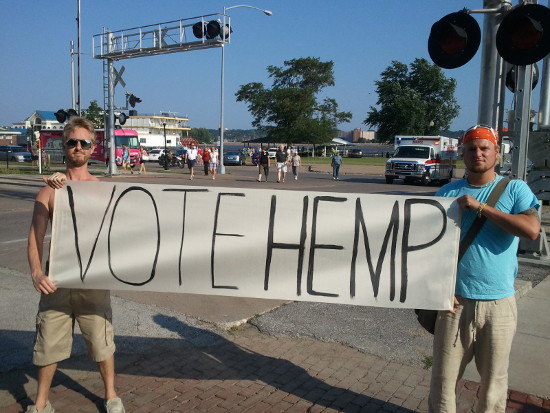 Jason Kakert (left) and Logan Edwards at the Mitt Romney rally June 18 at LeClaire Park in Davenport. Both individuals support Ron Paul, who claims that hemp is better for producing ethanol than corn (RCReader.com/y/hemp).