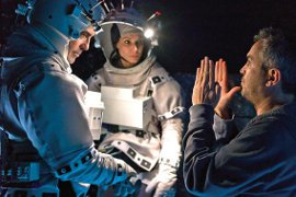 Alfonso Cuarón directs George Clooney and Sandra Bullock in Gravity