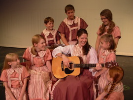 Liz J. Millea and the Von Trapp children in The Sound of Music