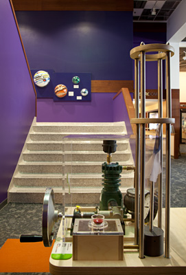 The rocket launcher (foreground) and a Putnam-made display of NASA-developed materials used in everyday life and encased in the Solar System's planets. Photo by AJ Brown Imaging.