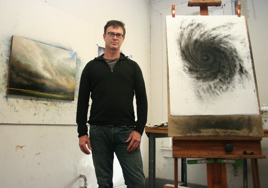 Drew Starenko with some of his recent work in his downtown-Davenport studio.