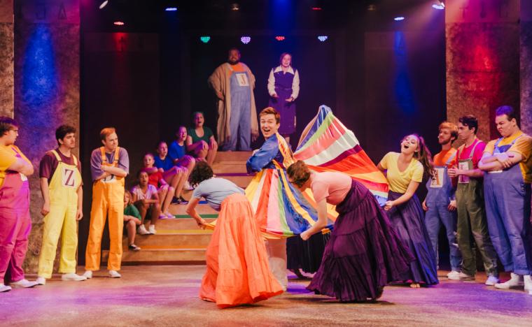 Josh Daniel and ensemble members in Joseph & the Amazing Technicolor Dreamcoat