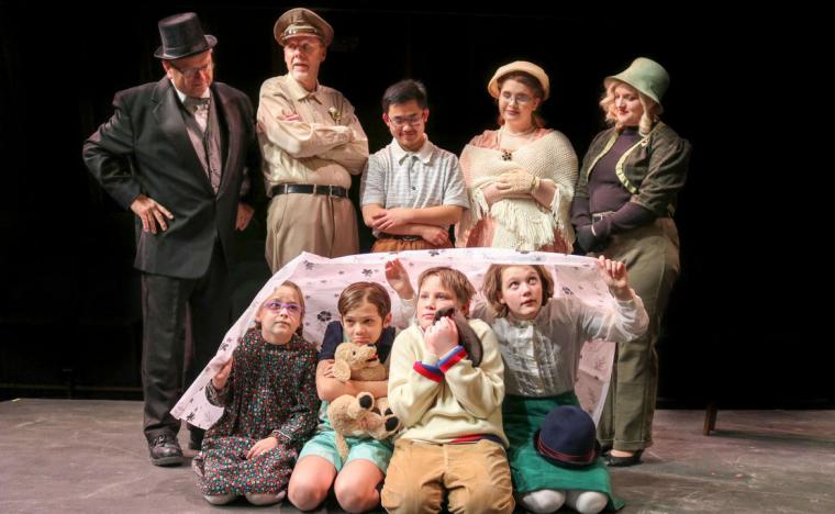 Jim Strauss, Don Faust, Nolan Schoenle, Jenya Loughney, Lauren Larson (standing), Madalyn Roland, Thom Elliott, Lennon Ross, and Chloe Hansen (seated) in The Boxcar Children