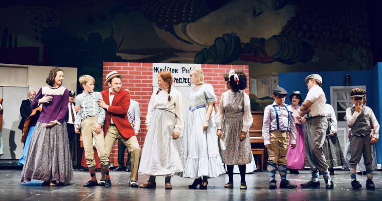 Kyle DeFauw (in red) and ensemble members in The Music Man