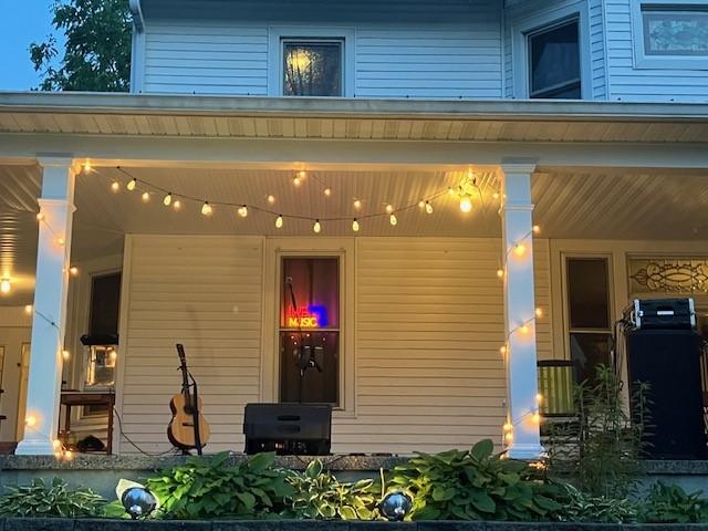 The porch lit up for the June 11 Sina Theil concert (photo by Jonathan Turner).