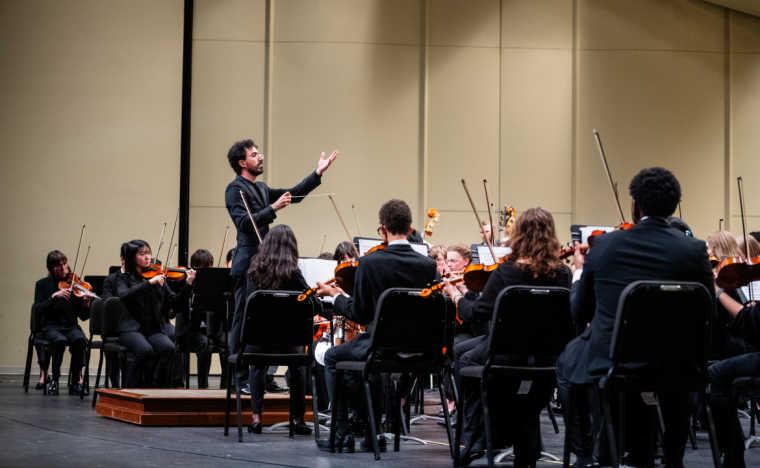 Hisham Bravo Groover, QCSO assistant conductor and head of the QCSO Youth Ensembles, leading the QC Youth Symphony Orchestra.