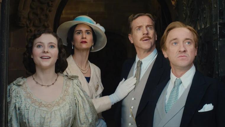 Thomasin McKenzie, Katherine Waterston, Damian Lewis, and Tom Felton in Fackham Hall