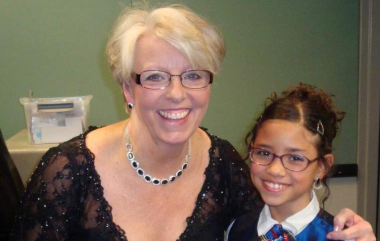 Ivy (right) at age 9, with Mary Tallitsch, who led the Quad City Holiday Pops Children's Choir from 2008 to 2013.