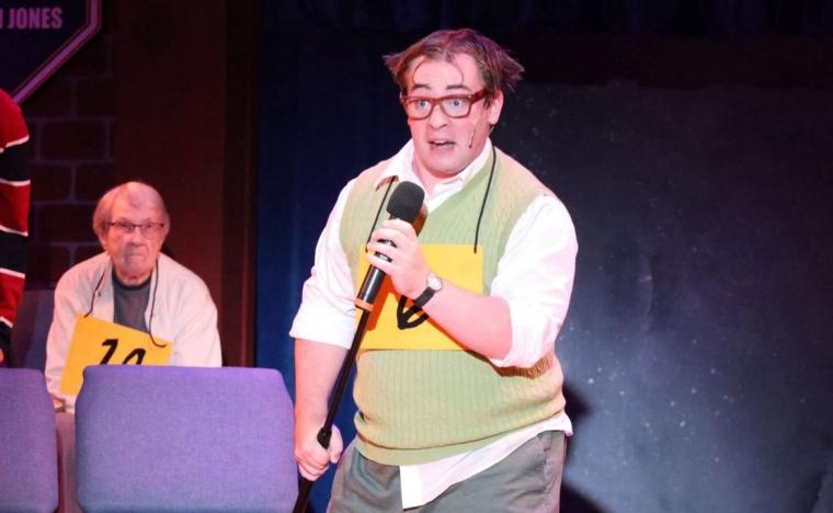 Caleb Cox (and an audience volunteer) in The 25th Annual Putnam County Spelling Bee