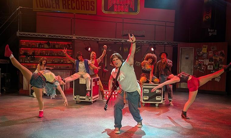 Tate Milton and ensemble members in Rock of Ages