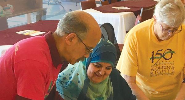 Jay Strickland (1952-2026) leading a paper peace crane workshop.